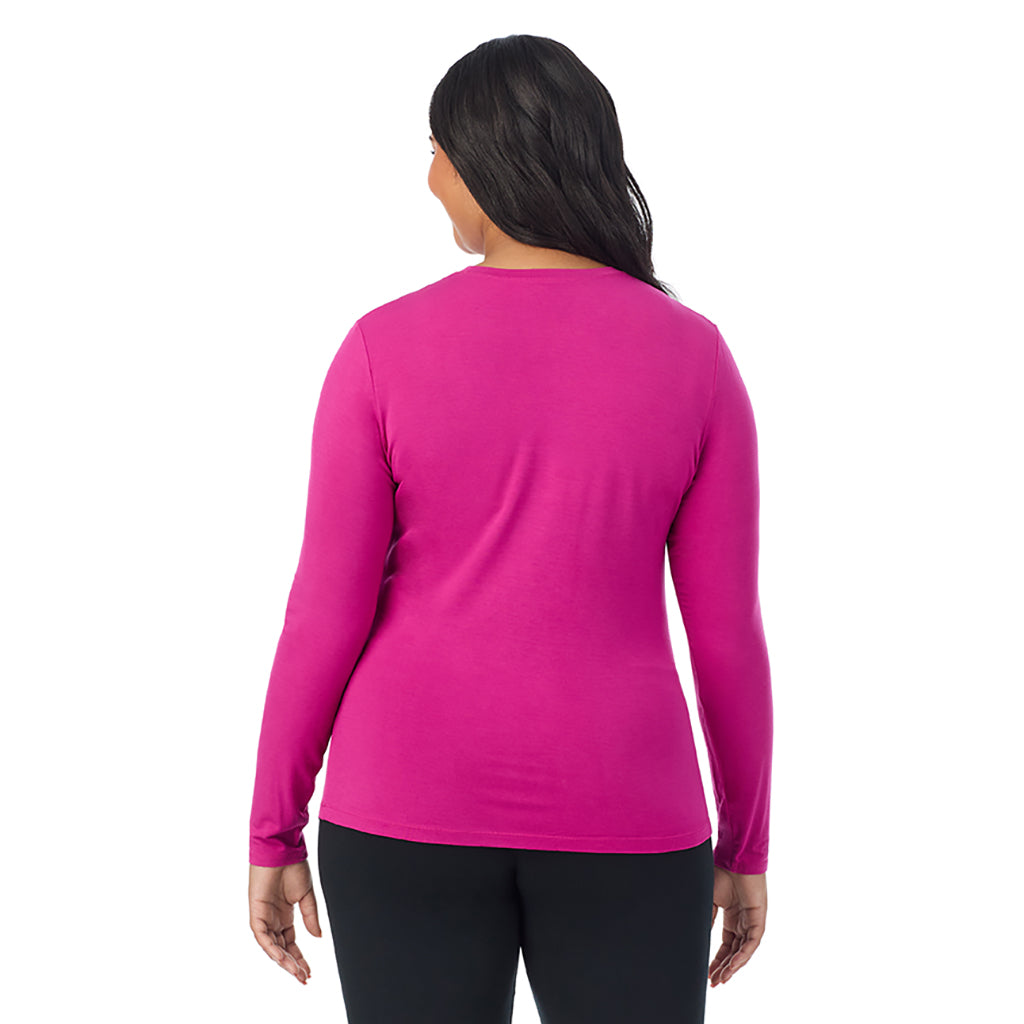 A lady wearing a deep fuschia long sleeve crew plus.