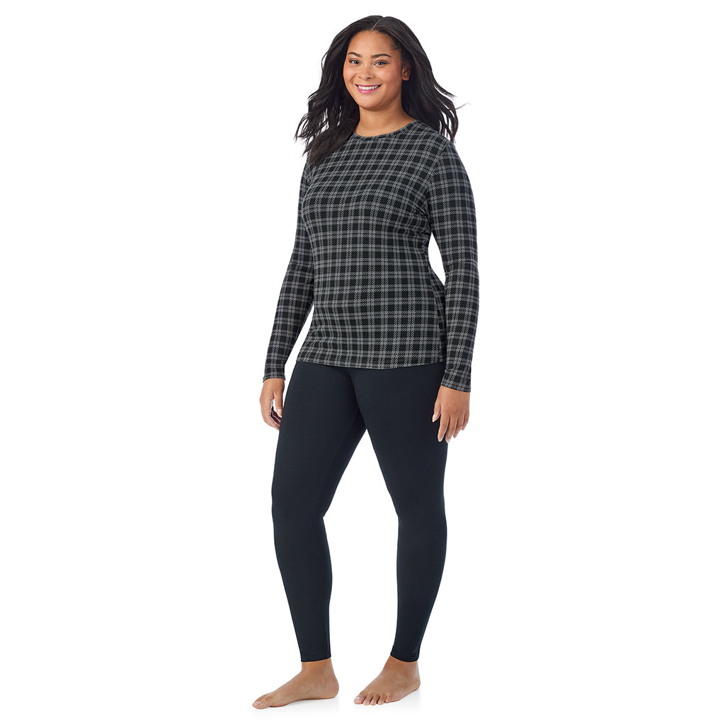 A lady wearing a charcoal/black plaid long sleeve crew plus.
