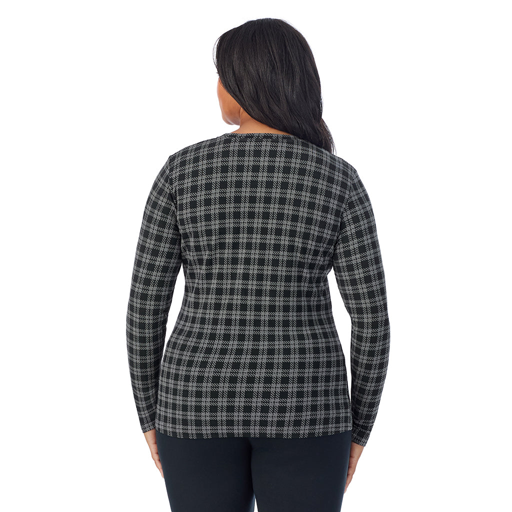 A lady wearing a charcoal/black plaid long sleeve crew plus.
