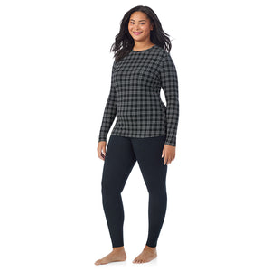 A lady wearing a charcoal/black plaid long sleeve crew plus.