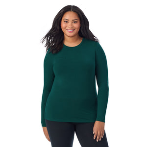 A lady wearing a dark pine long sleeve crew plus.