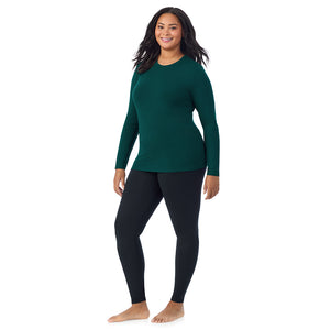 A lady wearing a dark pine long sleeve crew plus.