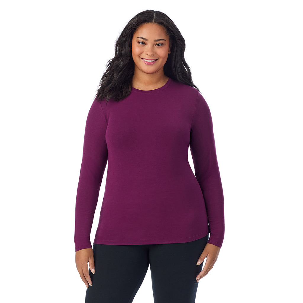 A lady wearing a dark purple long sleeve crew plus.