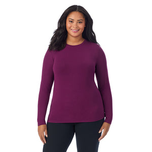 A lady wearing a dark purple long sleeve crew plus.