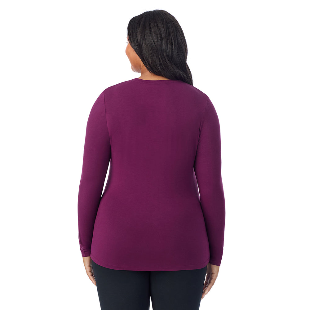 A lady wearing a dark purple long sleeve crew plus.