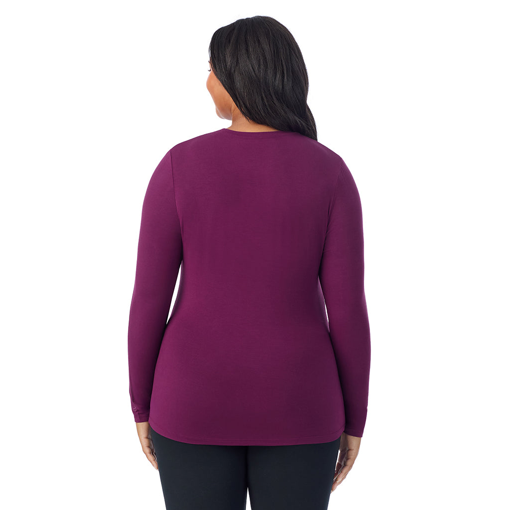 A lady wearing a dark purple long sleeve crew plus.