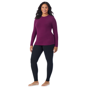 A lady wearing a dark purple long sleeve crew plus.