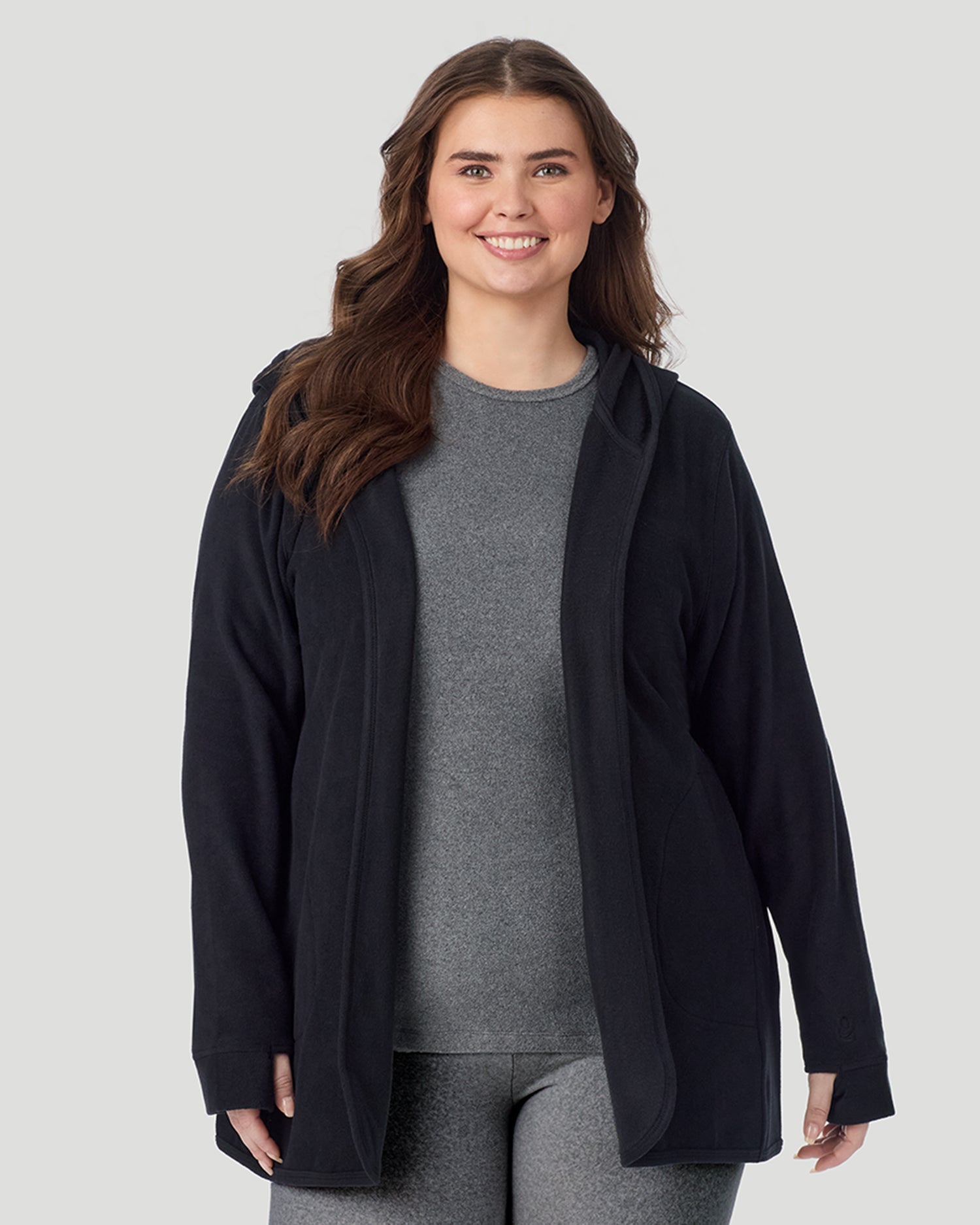 Black; Model is wearing size 1X. She is 5'10", Bust 44", Waist 36", Hips 49". @A plus size lady wearing Black Fleecewear with Stretch Wrap With Hood PLUS in a front view look