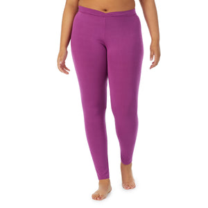 A lady wearing a Purple Radiance stretch legging plus.