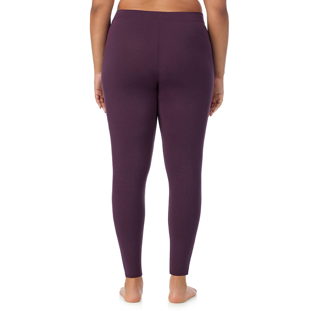 A lady wearing a boysenberry stretch legging plus.
