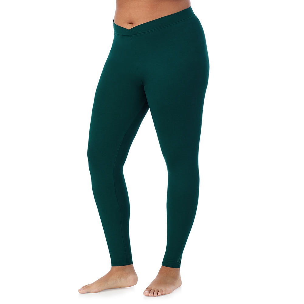 A lady wearing a dark pine stretch legging plus.