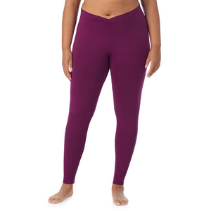 A lady wearing a dark purple stretch legging plus.