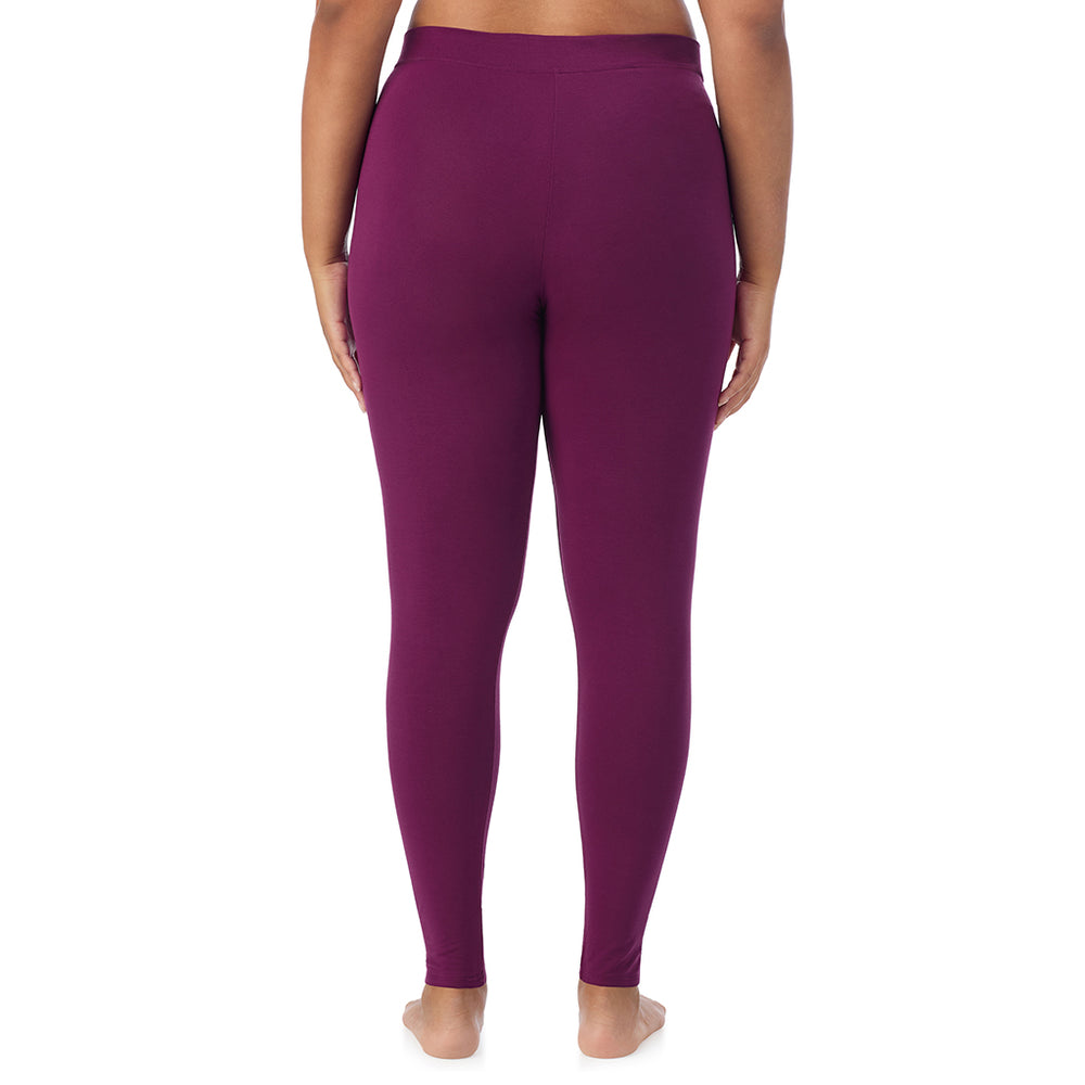 A lady wearing a dark purple stretch legging plus.