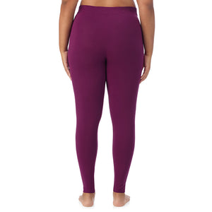 A lady wearing a dark purple stretch legging plus.