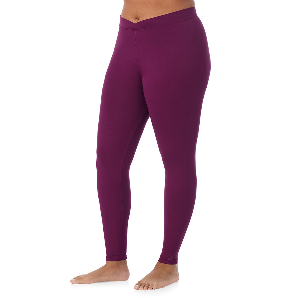 A lady wearing a dark purple stretch legging plus.