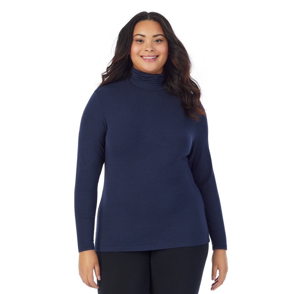 A lady wearing navy blazer long sleeve turtleneck plus softwear with stretch top.
