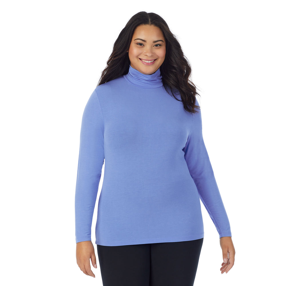 A lady wearing ultramarine long sleeve turtleneck plus softwear with stretch top.