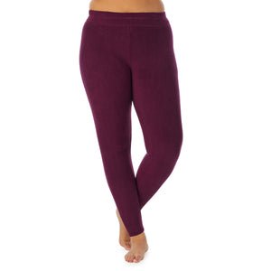 A lady wearing purple beet fleecewear with stretch legging plus. !59% Polyester, 35% Recycled Polyester, 6% Spandex !