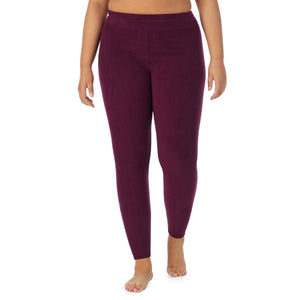 A lady wearing purple beet fleecewear with stretch legging plus. !59% Polyester, 35% Recycled Polyester, 6% Spandex !