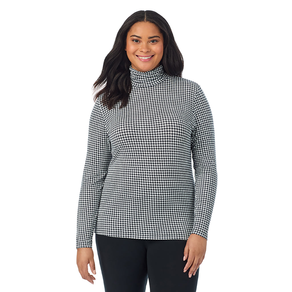 A lady wearing ivory houndstooth long sleeve turtleneck plus softwear with stretch top.