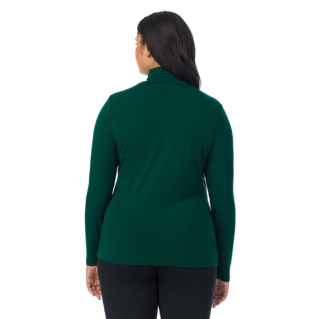 A lady wearing evergreen long sleeve turtleneck plus softwear with stretch top.