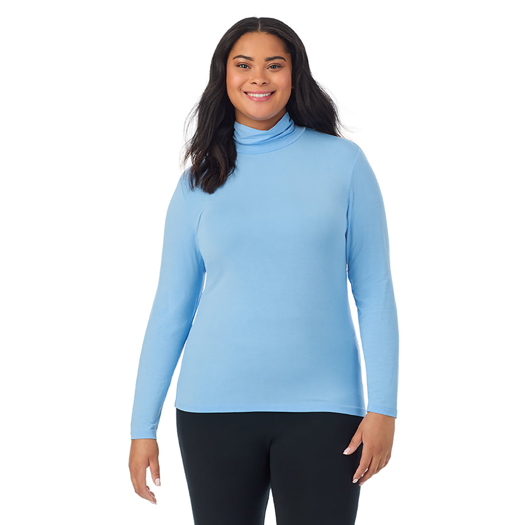 Vista Blue; Model is wearing size 1X. She is 5'11", Bust 36", Waist 36.5", Hips 47.5". @A lady wearing vista blue long sleeve turtleneck plus softwear with stretch top.