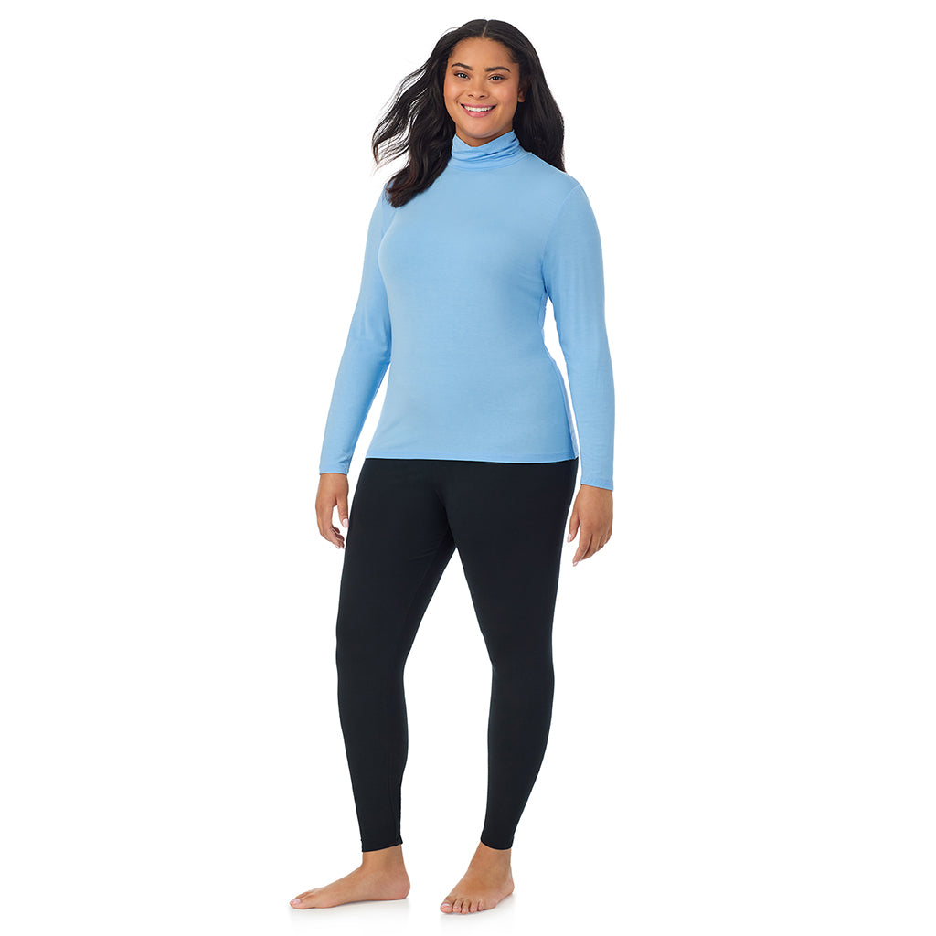 A lady wearing vista blue long sleeve turtleneck plus softwear with stretch top.