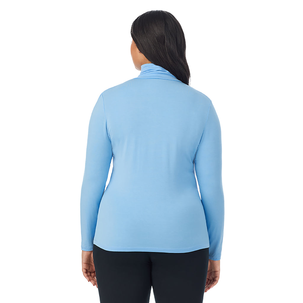 A lady wearing vista blue long sleeve turtleneck plus softwear with stretch top.