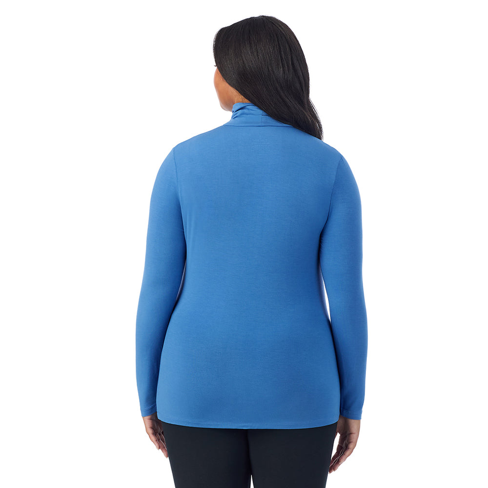 A lady wearing blue comet long sleeve turtleneck plus softwear with stretch top.