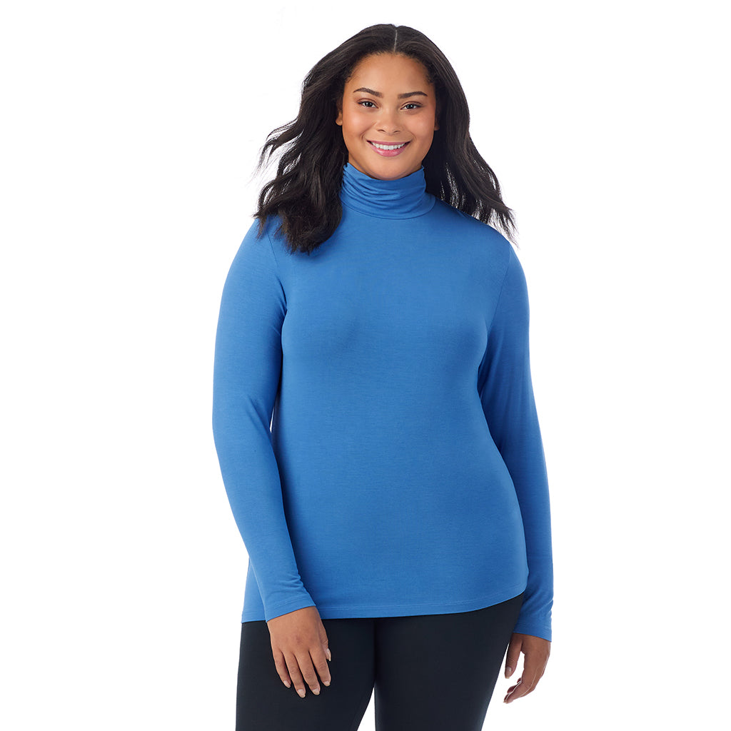 A lady wearing blue comet long sleeve turtleneck plus softwear with stretch top.