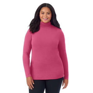 A lady wearing very berry long sleeve turtleneck plus softwear with stretch top.