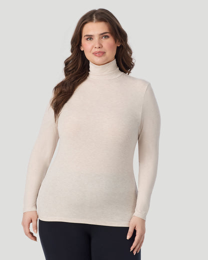  A plus size Lady wearing Oatmeal Heather Softwear With Stretch Long Sleeve Turtleneck PLUS in a front view pose