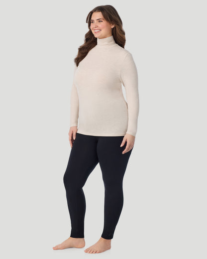  A plus size Lady wearing Oatmeal Heather Softwear With Stretch Long Sleeve Turtleneck PLUS in a front view standing pose