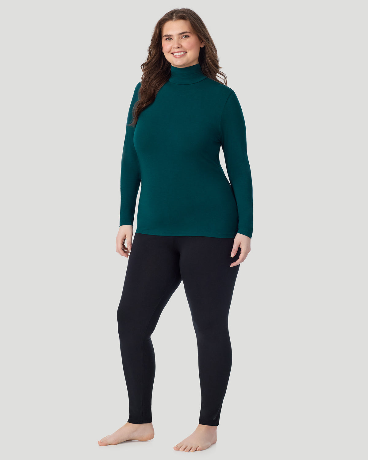 Deep Emerald; Model is wearing size 1X. She is 5'10", Bust 44", Waist 36", Hips 49". @ A plus size Lady wearing Deep Emerald Softwear With Stretch Long Sleeve Turtleneck PLUS in a front view standing pose