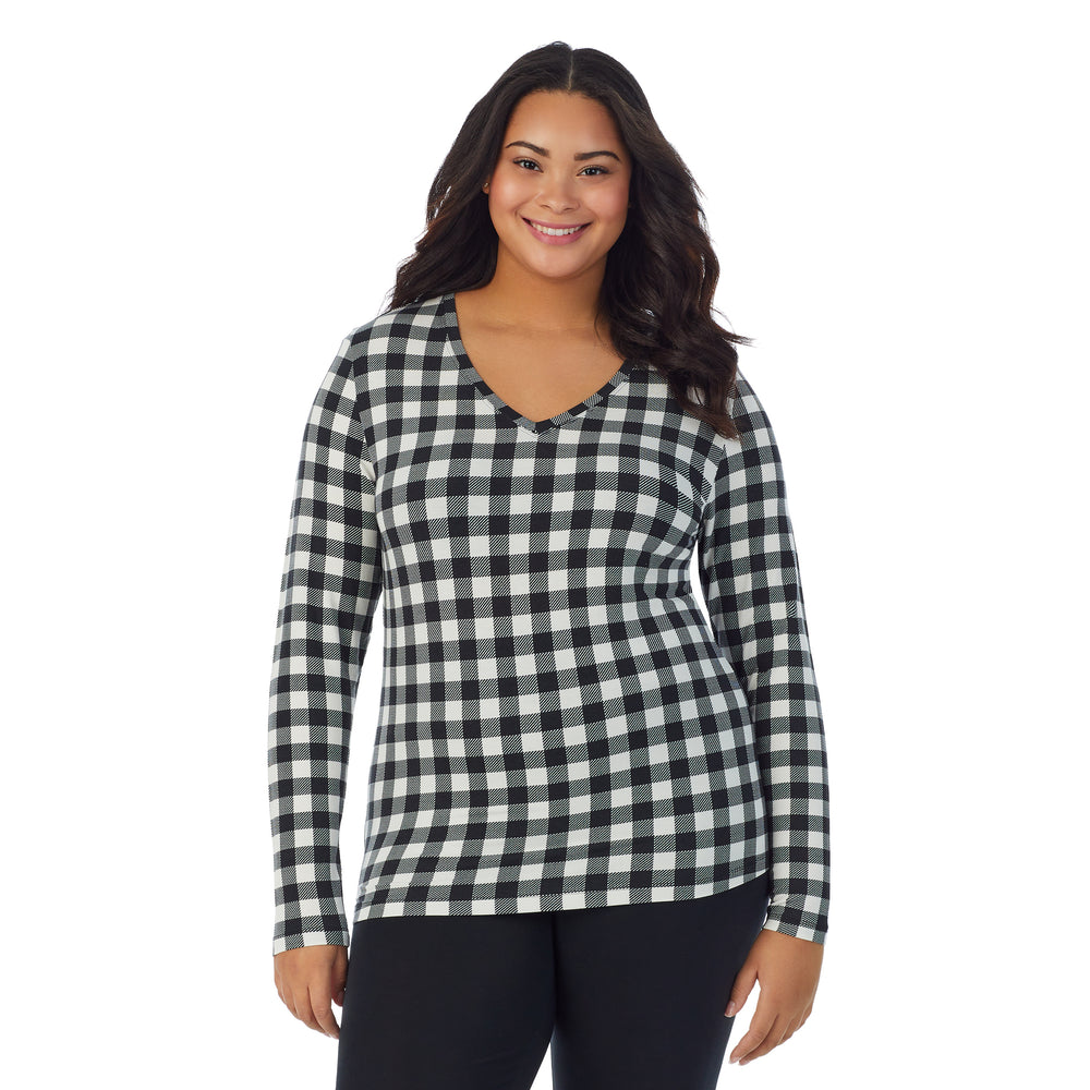 A lady wearing ivory buffalo long sleeve v-neck plus softwer with stretch top.
