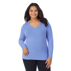 A lady wearing ultramarine long sleeve v-neck plus softwer with stretch top.