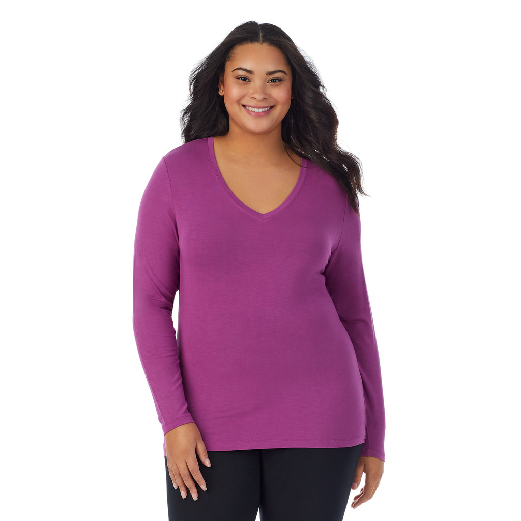 A lady wearing purple radiance long sleeve v-neck plus softwer with stretch top.