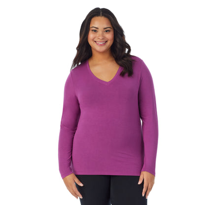 Purple Radiance; Model is wearing size 1X. She is 5'11", Bust 36", Waist 36.5", Hips 47.5". @A lady wearing purple radiance long sleeve v-neck plus softwer with stretch top.