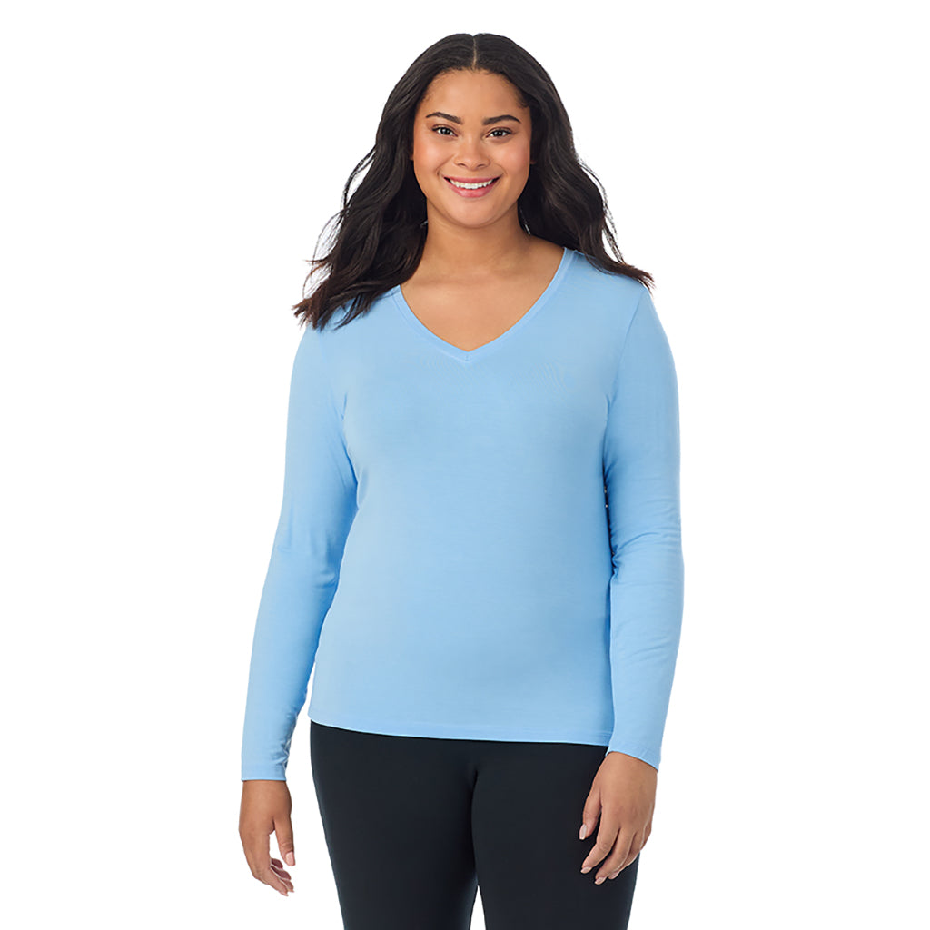 Vista Blue; Model is wearing size 1X. She is 5'11", Bust 36", Waist 36.5", Hips 47.5". @A lady wearing vista blue long sleeve v-neck plus softwer with stretch top.