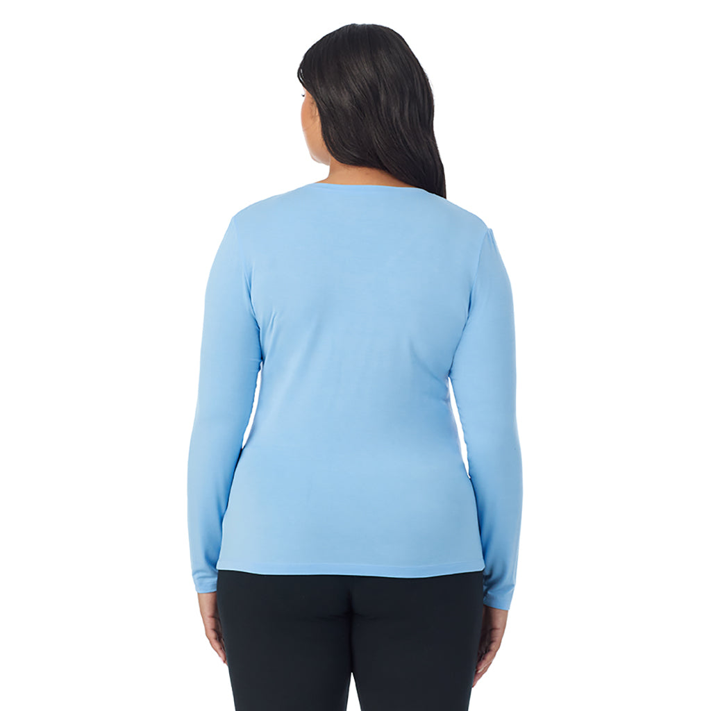 A lady wearing vista blue long sleeve v-neck plus softwer with stretch top.