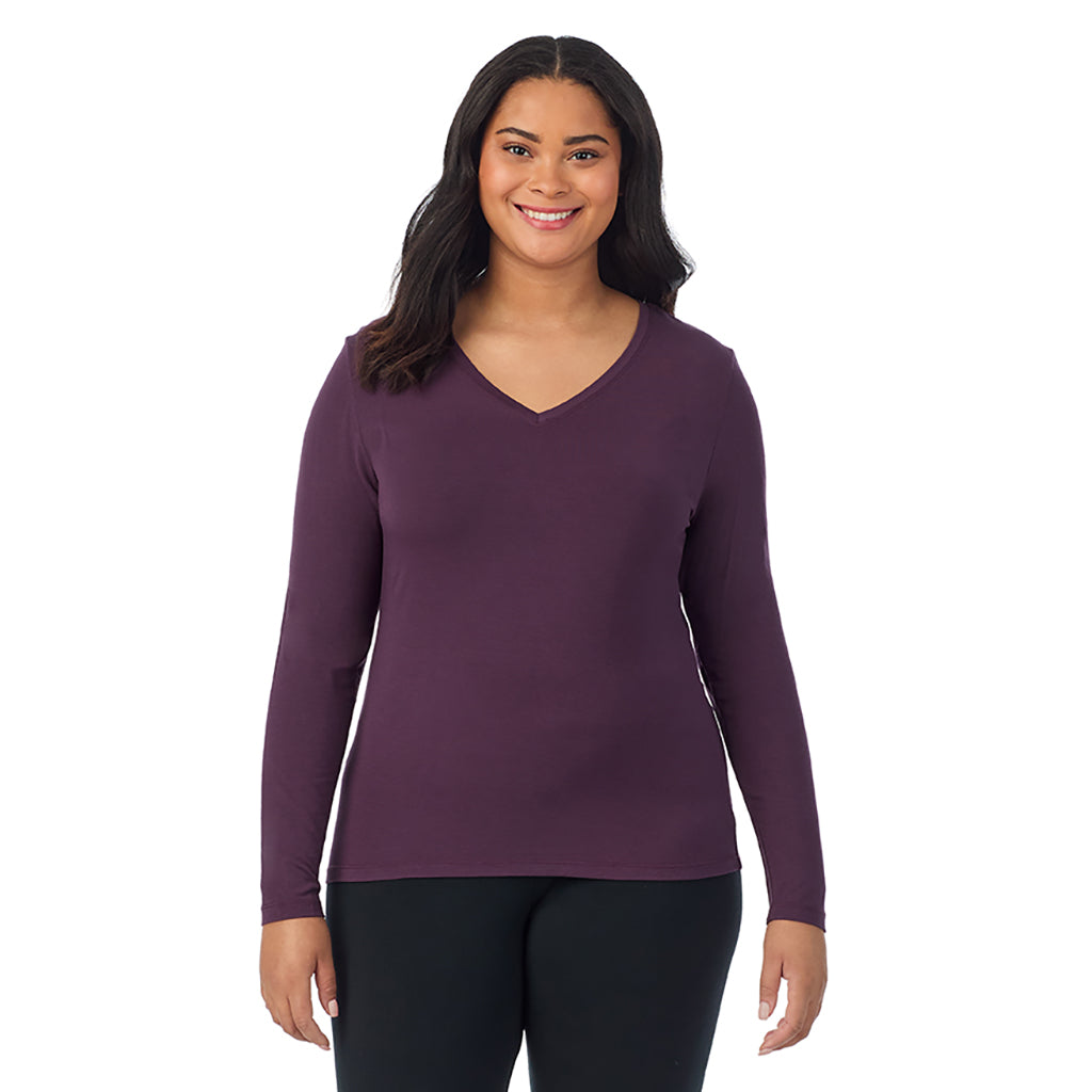 A lady wearing boysenberry long sleeve v-neck plus softwer with stretch top.