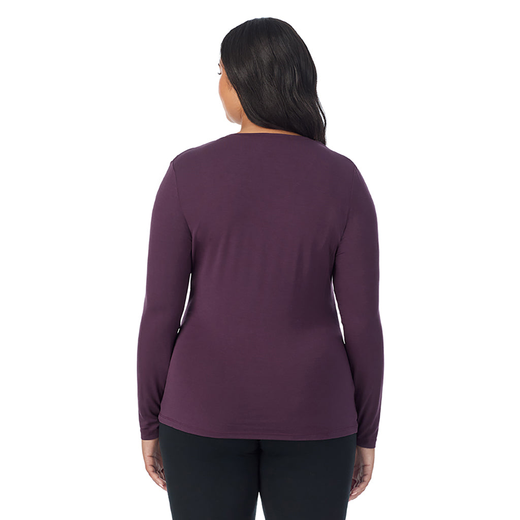 A lady wearing boysenberry long sleeve v-neck plus softwer with stretch top.