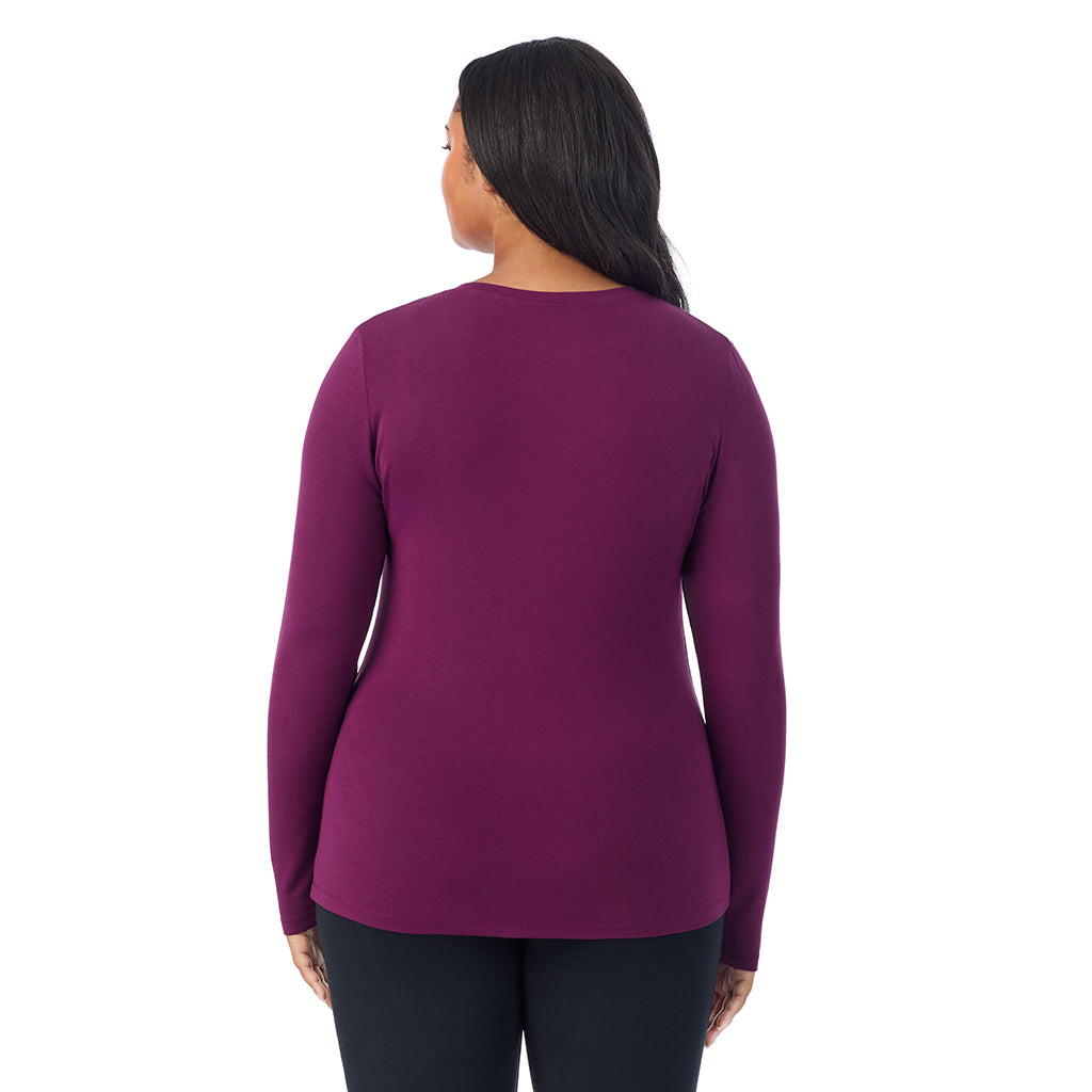 A lady wearing dark purple long sleeve v-neck plus softwer with stretch top.