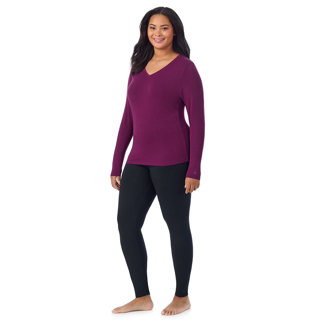 A lady wearing dark purple long sleeve v-neck plus softwer with stretch top.