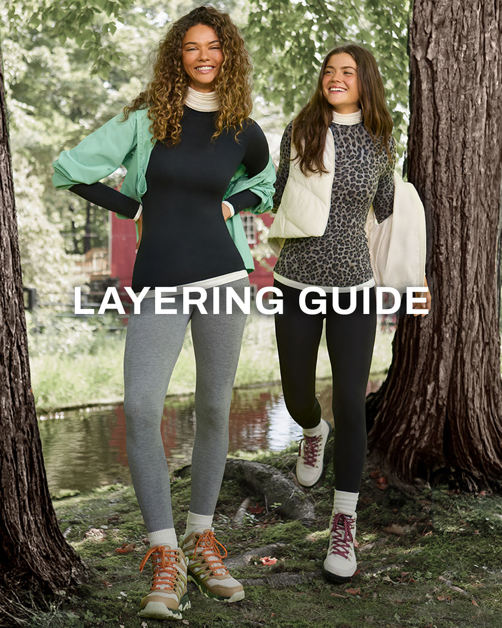 Layering Guide. Two women in turtleneck base layers, leggings and hiking boots walk among trees.