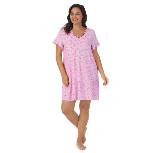A lady wearing pink short sleeve sleep shirt with pink dragonfly print