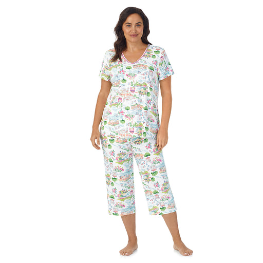 A lady wearing white short sleeve top with cropped pant pajama set with white scenery print