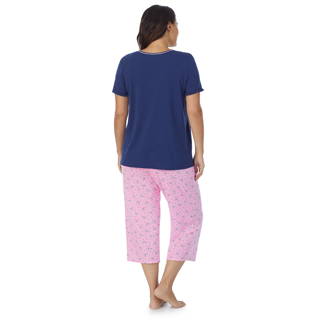 Pink Dragonfly;Model is wearing size 1X. She is 5'11.5", Bust 41", Waist 33", Hips 46"@A lady wearing short sleeve top with cropped pant pajama set with pink dragonfly print