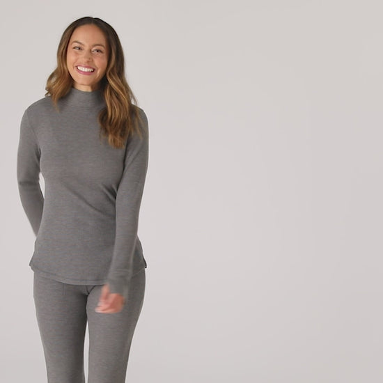 @ A lady is wearing a Cozy Stretch Thermal Long Sleeve Mock Neck