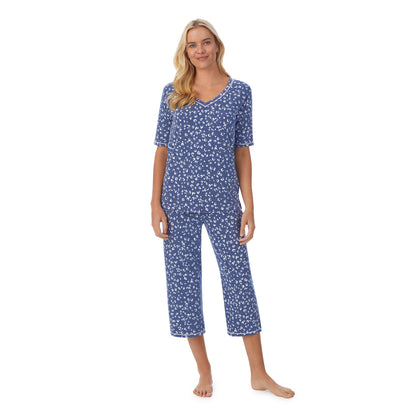 Navy Animal;Model is wearing size S. She is 5'9", Bust 34", Waist 26", Hips 36".@ A lady wearingCuddl Smart Elbow Sleeve Top with Cropped Pant Pajama Set with Navy Animal print